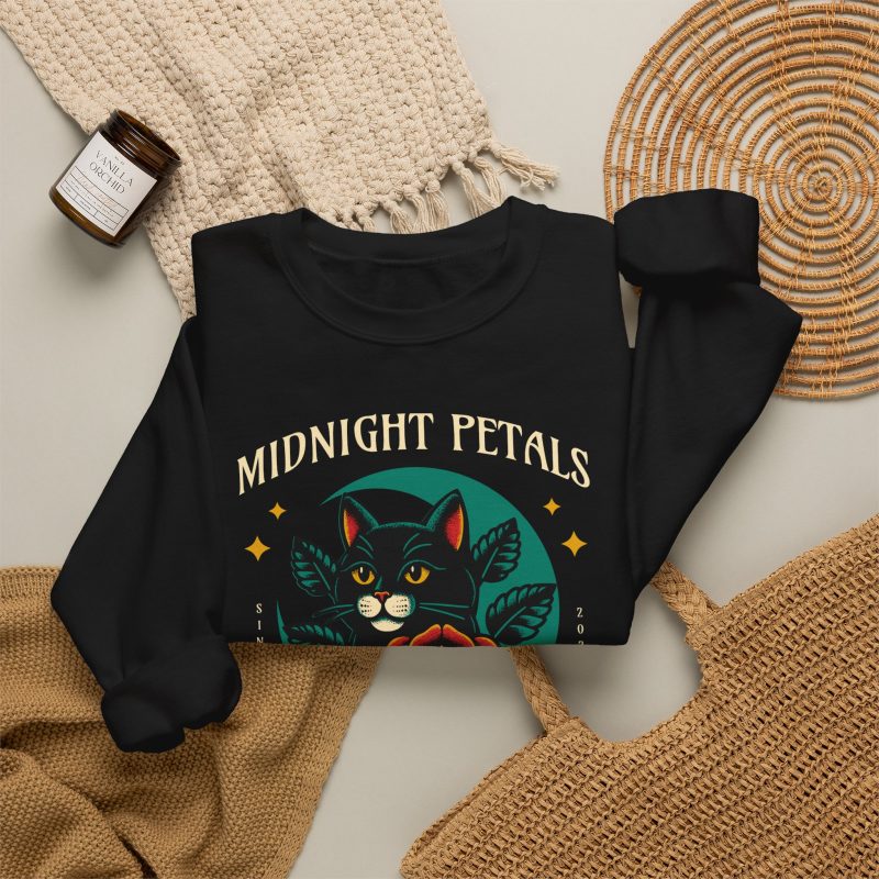 Detail of the black cat with a red rose and golden stars graphic on the crewneck sweatshirt