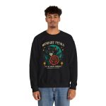 Person wearing a crewneck sweatshirt with a black cat with a red rose and golden stars graphic on the front