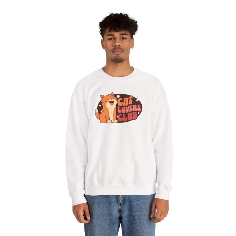 Person wearing a crewneck sweatshirt with a smiling orange tabby beside retro lettering in an oval badge with hearts and starbursts printed on the front