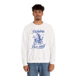 Person wearing a sweatshirt with a blue cat on a bicycle