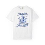 A blue tabby riding a bicycle with a basket printed on the front of a shirt A blue tabby riding a bicycle with a basket printed on the front of a shirt
