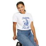 Person wearing a shirt with a blue cat on a bicycle Person wearing a shirt with a blue cat on a bicycle