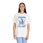 Person wearing a shirt with a blue cat on a bicycle Person wearing a shirt with a blue cat on a bicycle