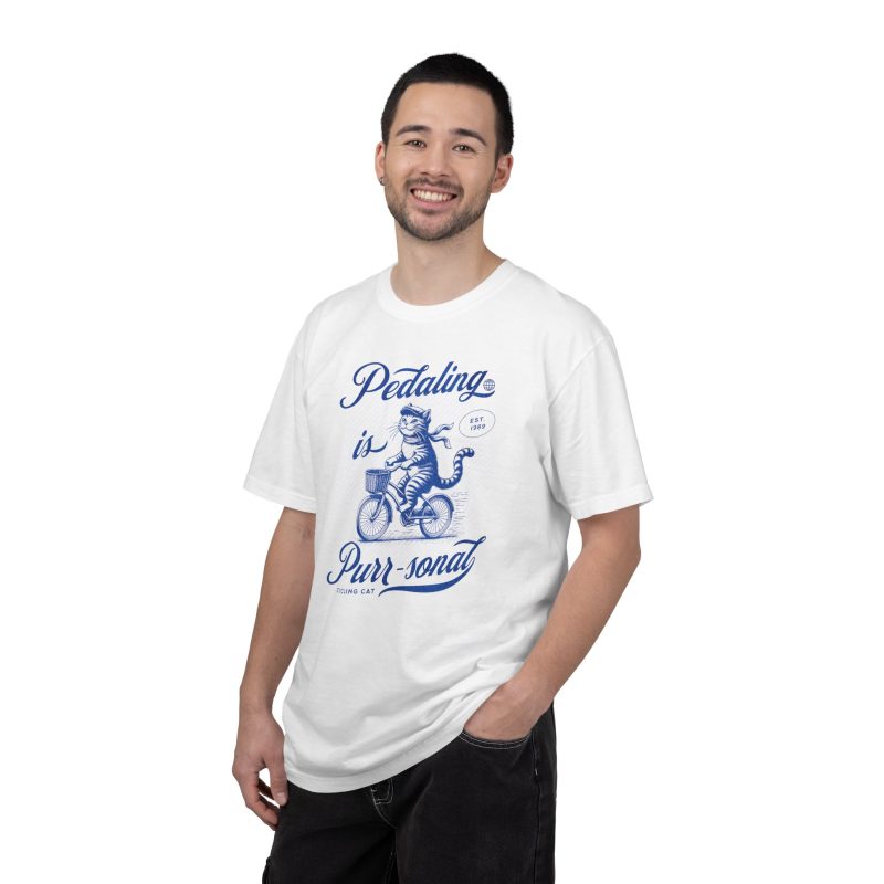 Person wearing a shirt with a blue cat on a bicycle