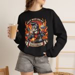 Person wearing a sweatshirt with a guitar-playing rockabilly cat