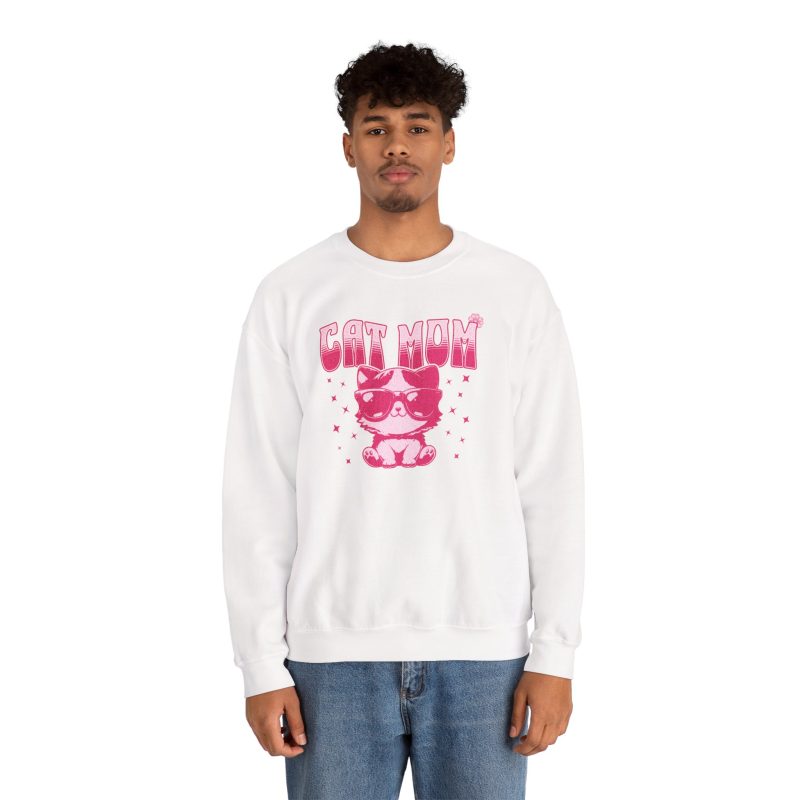 Person wearing a crewneck sweatshirt with a seated kitten in oversized sunglasses with pink striped lettering and stars printed on the front