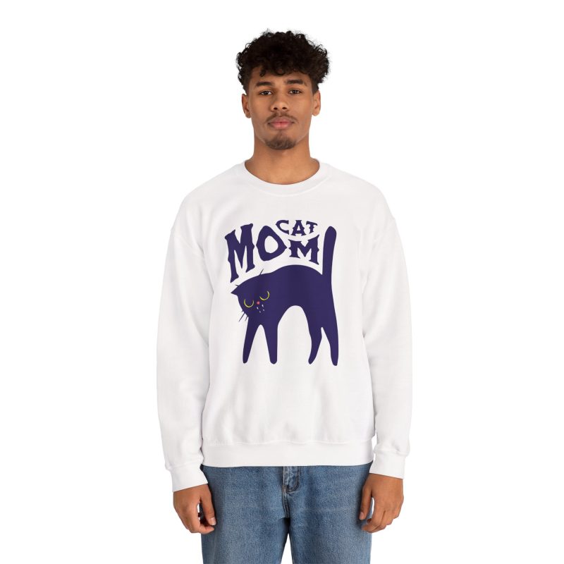 Person wearing a crewneck sweatshirt with a navy arched cat and wavy lettering graphic on the front