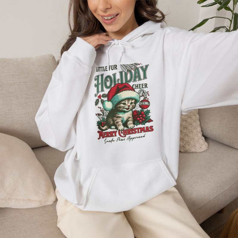 Person wearing a hoodie with a Santa-hat kitten with holly and an ornament graphic on the front