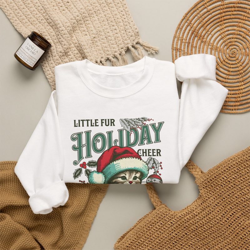 Detail of the Santa-hat kitten with holly and an ornament graphic on the crewneck sweatshirt