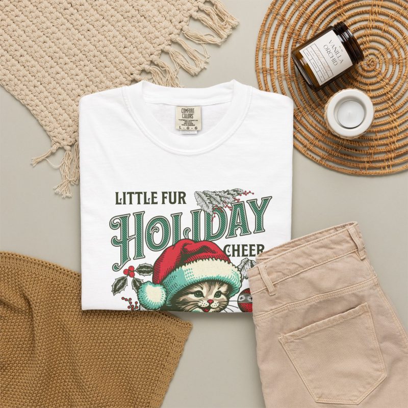 Detail of the Santa-hat kitten with holly and an ornament graphic on the tee