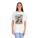 Person wearing a tee with a Santa-hat kitten with holly and an ornament graphic on the front