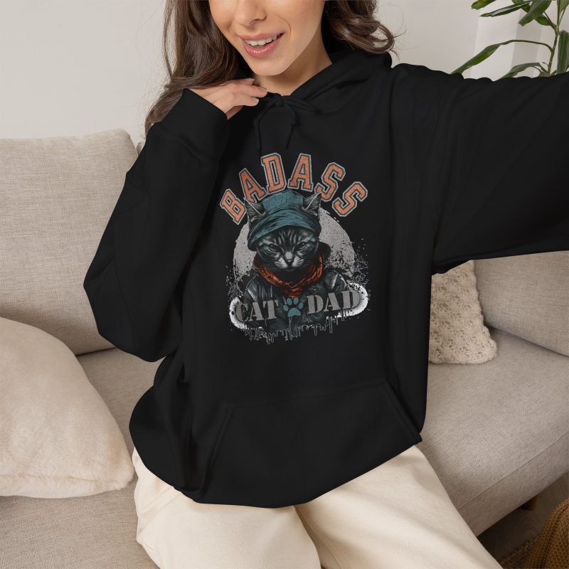 Person wearing a hoodie with a tabby in a cap, jacket and scarf graphic on the front