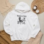 Detail of the cat reading a book at a café table graphic on the hoodie