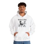 Person wearing a hoodie with a cat reading a book at a café table graphic on the front