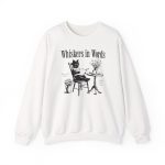 Front of the crewneck sweatshirt showing the cat reading a book at a café table graphic Front of the crewneck sweatshirt showing the cat reading a book at a café table graphic