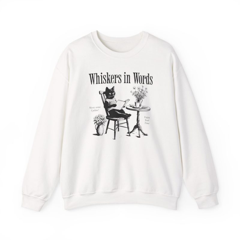 Front of the crewneck sweatshirt showing the cat reading a book at a café table graphic