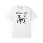 Front of the tee showing the cat reading a book at a café table graphic Front of the tee showing the cat reading a book at a café table graphic