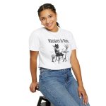 Person wearing a tee with a cat reading a book at a café table graphic on the front Person wearing a tee with a cat reading a book at a café table graphic on the front