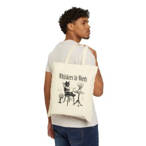 Person carrying a natural canvas tote with the cat reading a book at a café table graphic facing outward