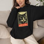Person wearing a hoodie with a bold cat portrait and red panel