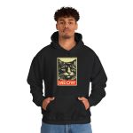 Person wearing a hoodie with a bold cat portrait and red panel