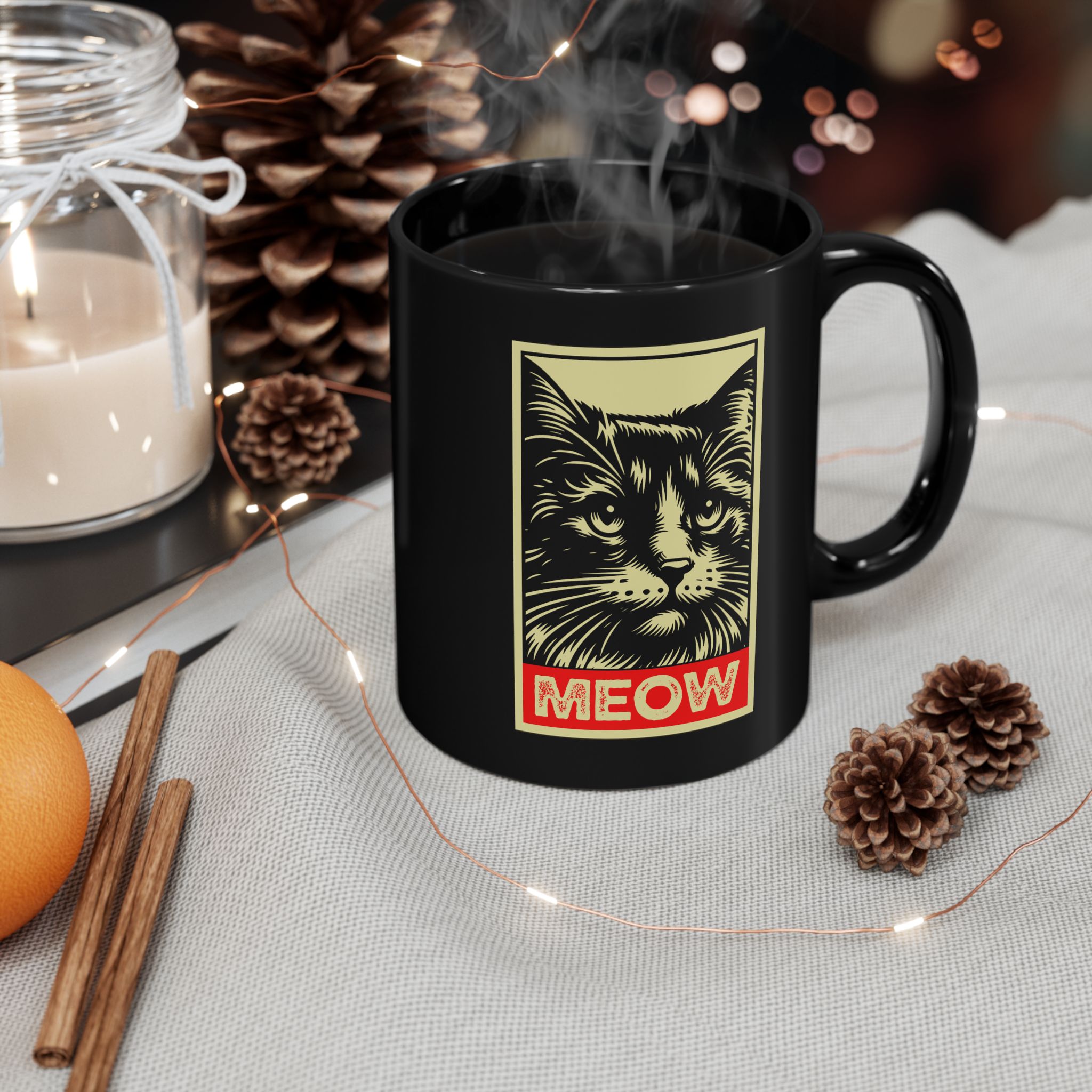 A bold cat portrait above a red lettering panel printed on a glossy black ceramic mug