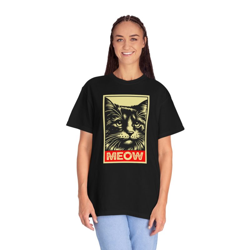 Person wearing a shirt with a bold cat portrait and red panel
