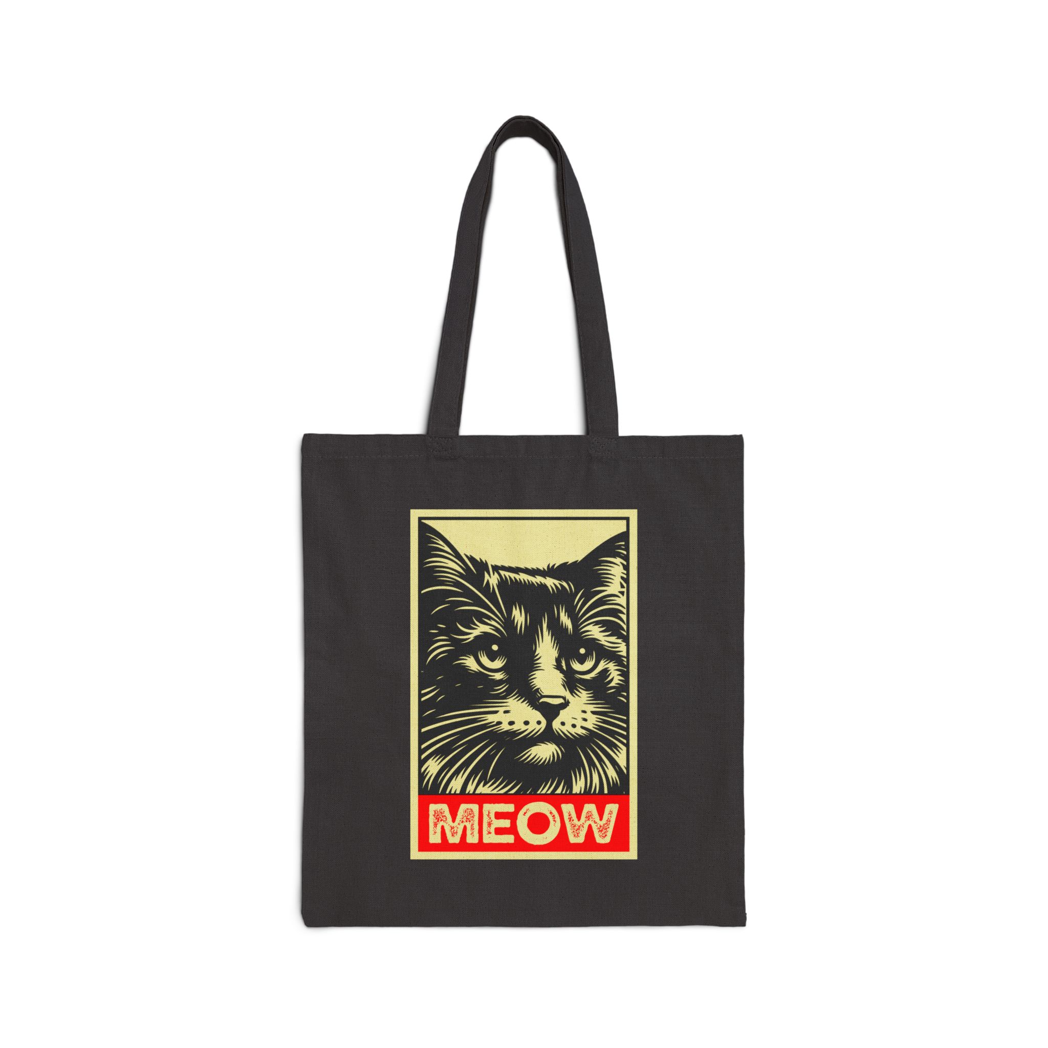 A bold cat portrait above a red lettering panel printed on the front of a black canvas tote