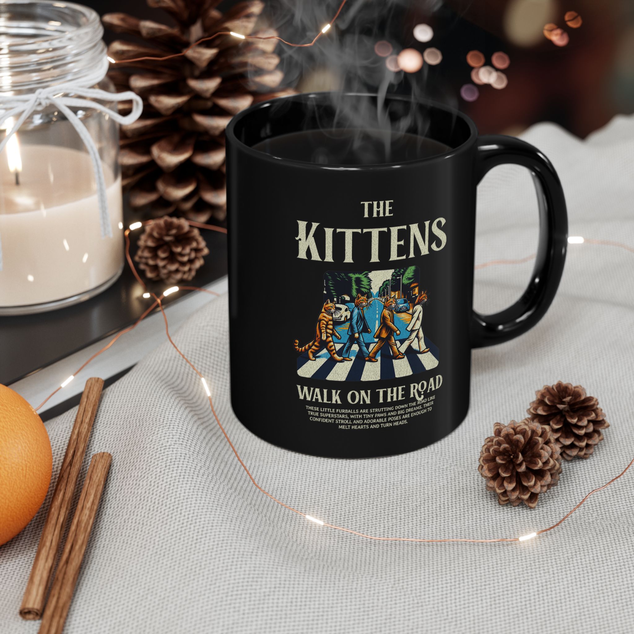 Four tabby cats crossing a street in a vintage illustration printed on a glossy black ceramic mug