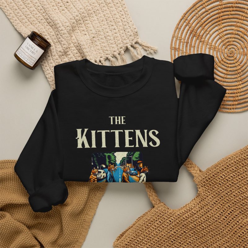 Four tabby cats crossing a street in a vintage illustration with The Kittens Walk on the Road lettering