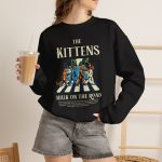 Person wearing a sweatshirt with crosswalk kittens
