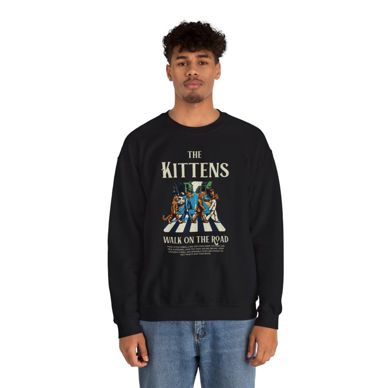 Person wearing a sweatshirt with crosswalk kittens