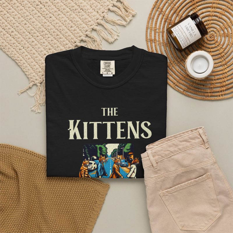 Four tabby cats crossing a street in a vintage illustration with The Kittens Walk on the Road lettering