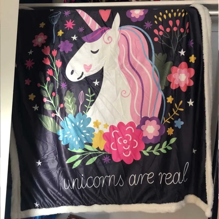 Photo from Marie J.’s review: Unicorns Are Real sherpa blanket hanging at home